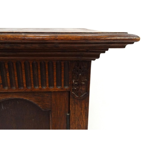 83 - Carved oak two door side cabinet, 74cm high x 57cm wide x 35cm deep