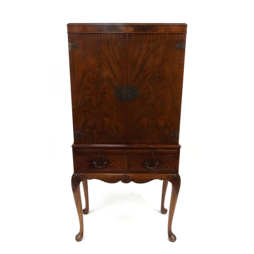 22 - Carved mahogany two door side cabinet with carved decoration raised on cabriole legs, 160cm high x 8... 