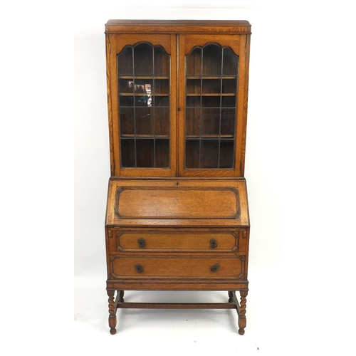 9 - Oak bureau bookcase fitted with leaded glass doors above a fall and two drawers, 200cm high x 90cm w... 