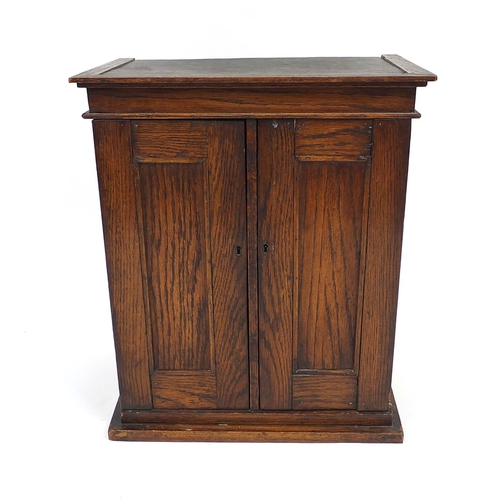 55 - Oak two door table top cabinet, 57cm high x 48cm wide x 30cm deep