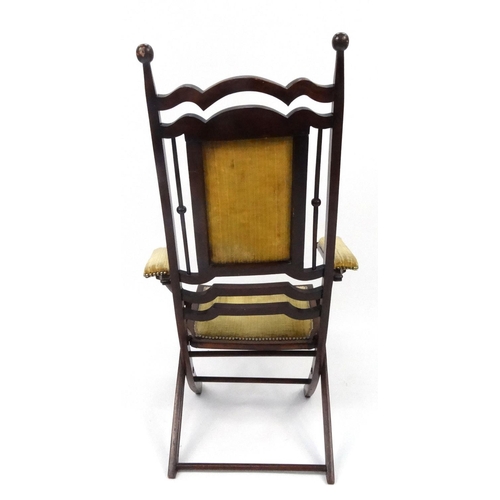 6 - Folding mahogany armchair with gold upholstered back, seat and arms