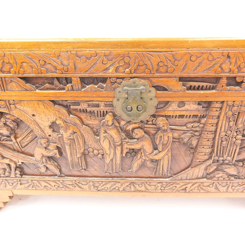 2 - Oriental  camphorwood trunk carved with figures amongst landscapes, 47cm high x 94cm wide x 45cm dee... 