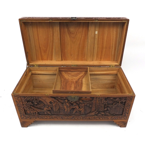 2 - Oriental  camphorwood trunk carved with figures amongst landscapes, 47cm high x 94cm wide x 45cm dee... 