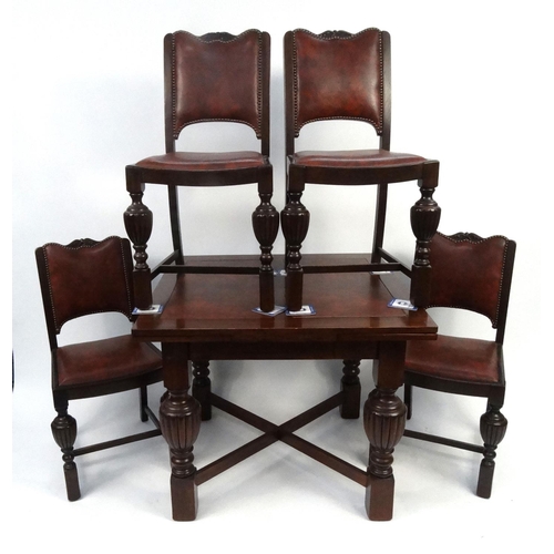 88 - Oak draw leaf dining table and four chairs with leatherette backs and seats