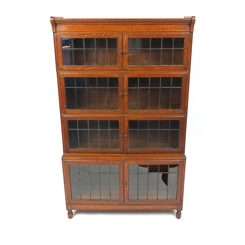 30 - Minty oak four section bookcase with leaded glass doors, 150cm high x 90cm wide x 29cm deep