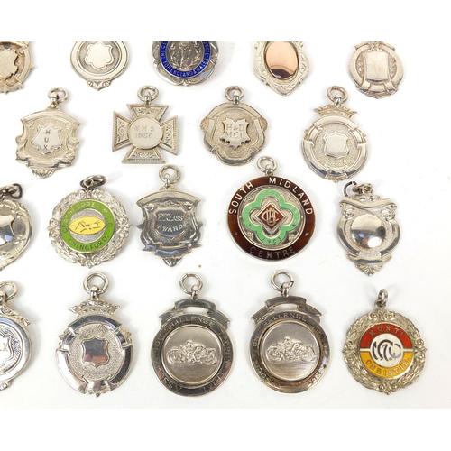 166 - Collection of twenty seven silver motorcycling jewels, some 1930's examples, mostly awarded to E Ken... 