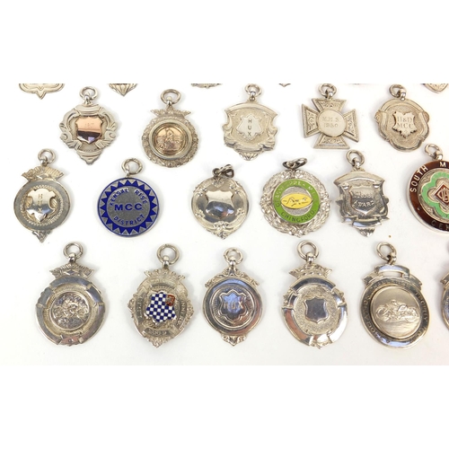 166 - Collection of twenty seven silver motorcycling jewels, some 1930's examples, mostly awarded to E Ken... 