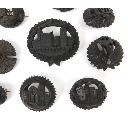 14 - Collection of Irish Bog oak brooches including examples carved with castles and harps together with ... 