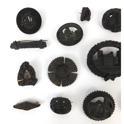 14 - Collection of Irish Bog oak brooches including examples carved with castles and harps together with ... 