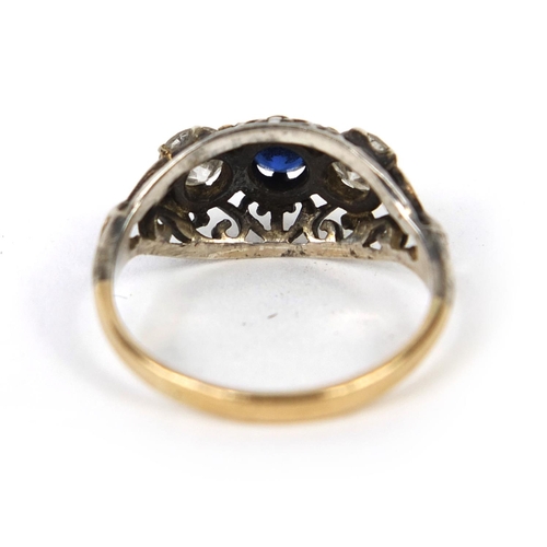 746 - Unmarked gold sapphire and diamond ring, set with two diamonds either side of a central saphire and ... 