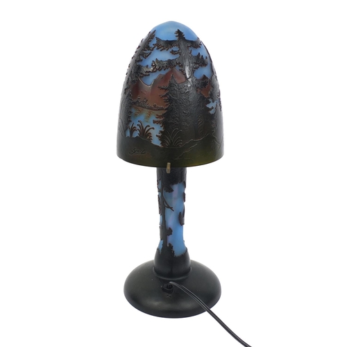 2057 - Galle style cameo glass table lamp decorated in low relief with a forest landscape scene, 47cm high