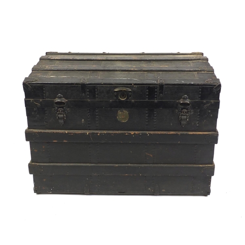 2009 - Vintage wooden bound steamer trunk with leather carrying handles the hinged lid opening to reveal a ... 