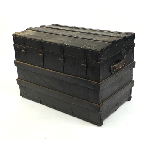 2009 - Vintage wooden bound steamer trunk with leather carrying handles the hinged lid opening to reveal a ... 