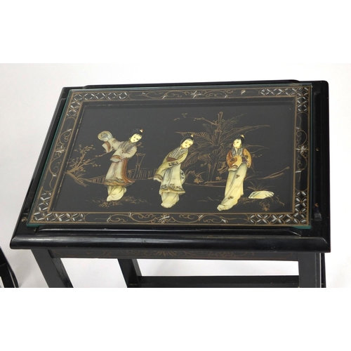 2032 - Nest of four Oriental lacquered occasional tables, each inlaid and hand painted with figures, the la... 