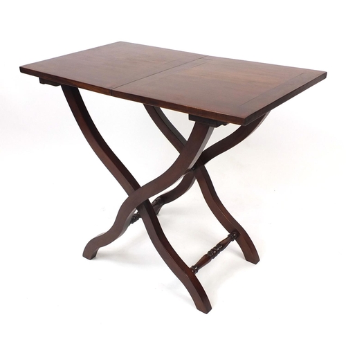 2025 - Folding mahogany campaign table with X frame legs, 69cm high x 82cm wide x 46cm deep