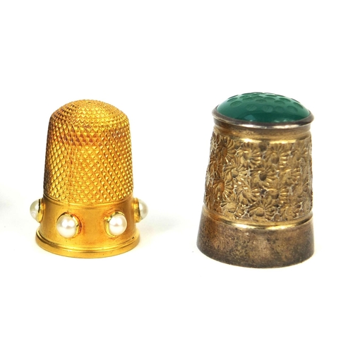 73 - Three thimbles comprising a gold coloured metal example set with six pearls housed in a Victorian ve... 