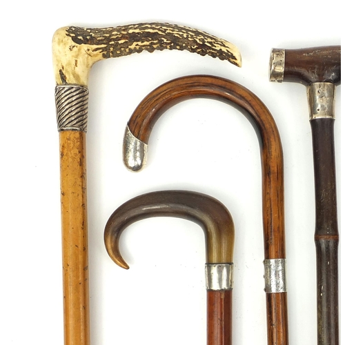 32 - Group of six walking sticks and one riding crop, mostly with silver collars including Malacca and ex... 