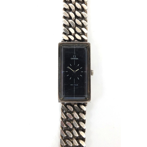 858 - Boxed ladies silver Omega Devil Wristwatch with black dial and bevelled glass on a silver strap, wit... 