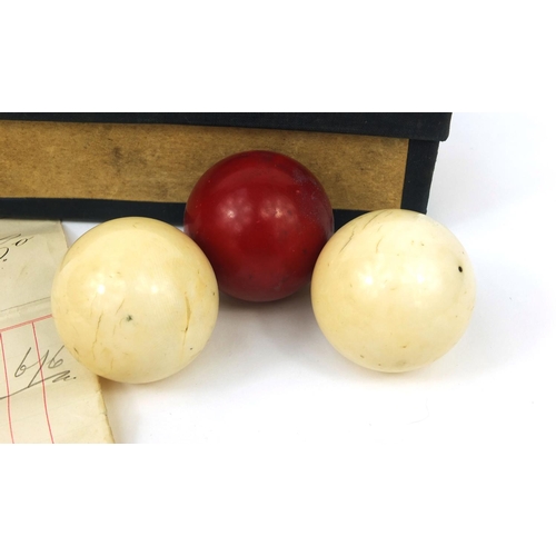 147 - Boxed set of three Victorian ivory billiard balls including a stained red example, together with ori... 