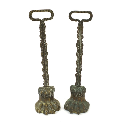 132 - Pair of Victorian brass lion paw door stops, each 39cm high