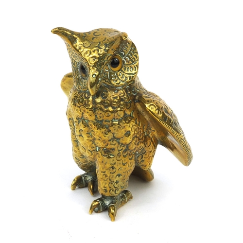 135 - Heavy brass owl paperweight with beaded glass eyes, impressed marks to the underside, 11cm high