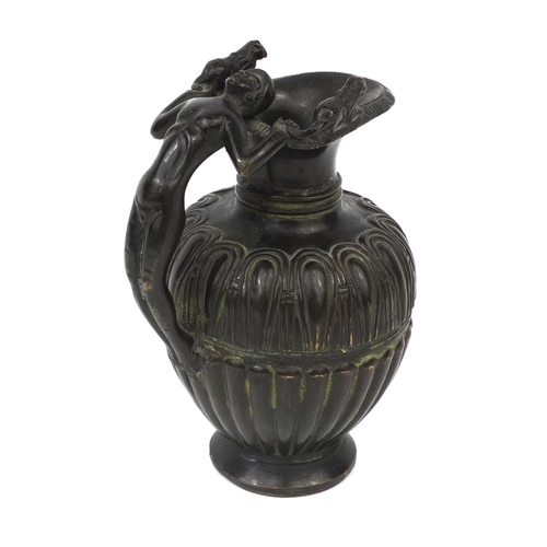 129 - Victorian bronze pitcher with figural handle and fluted body, 11cm high