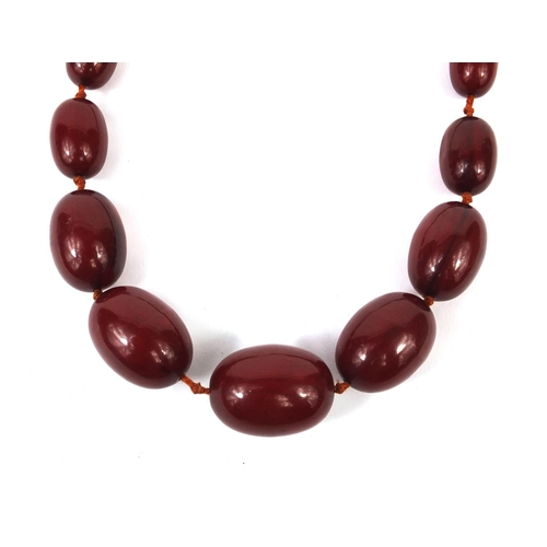 834 - Cherry amber coloured bead necklace, 100cm long, approximate weight 93.6g