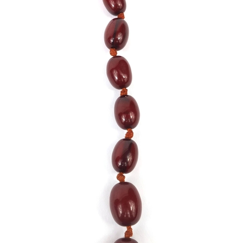 834 - Cherry amber coloured bead necklace, 100cm long, approximate weight 93.6g