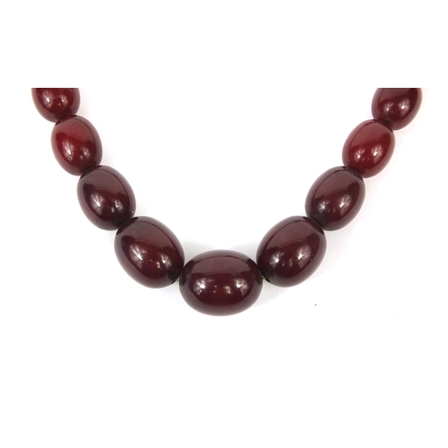 833 - Cherry amber coloured bead necklace, 70cm long, approximate weight 84.2g