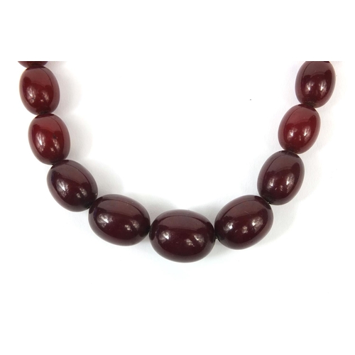 833 - Cherry amber coloured bead necklace, 70cm long, approximate weight 84.2g