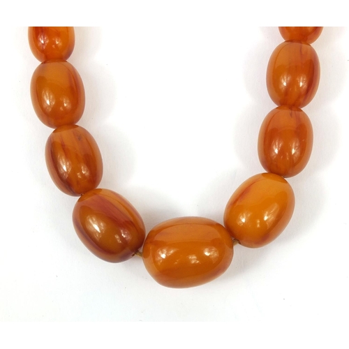 831 - Butterscotch amber coloured bead necklace, 64cm long, approximate weight 87.5g