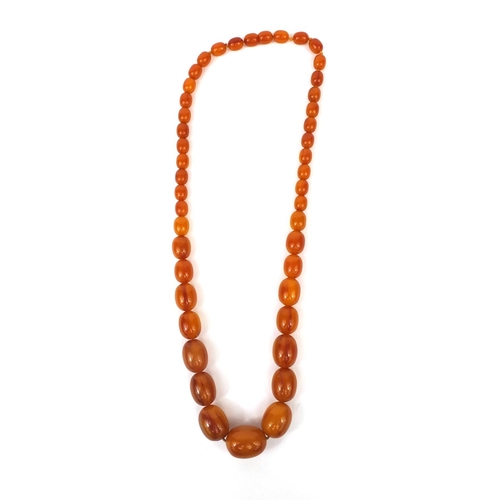 831 - Butterscotch amber coloured bead necklace, 64cm long, approximate weight 87.5g