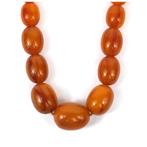 831 - Butterscotch amber coloured bead necklace, 64cm long, approximate weight 87.5g