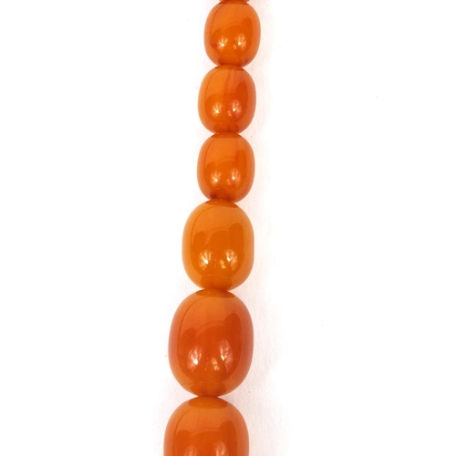 831 - Butterscotch amber coloured bead necklace, 64cm long, approximate weight 87.5g