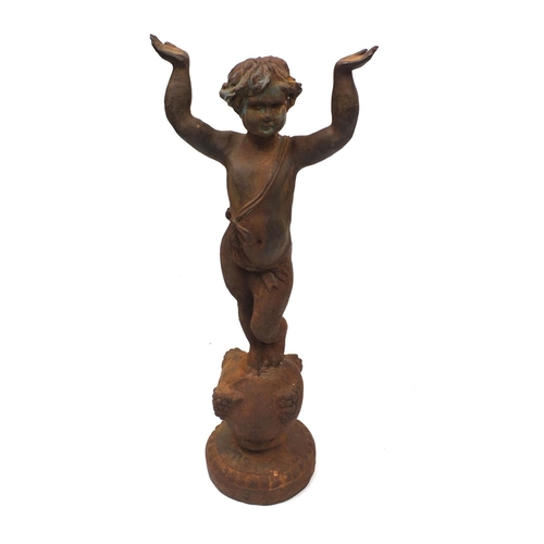 128 - Cast iron garden statue of a semi nude boy with raised arms, 80cm high