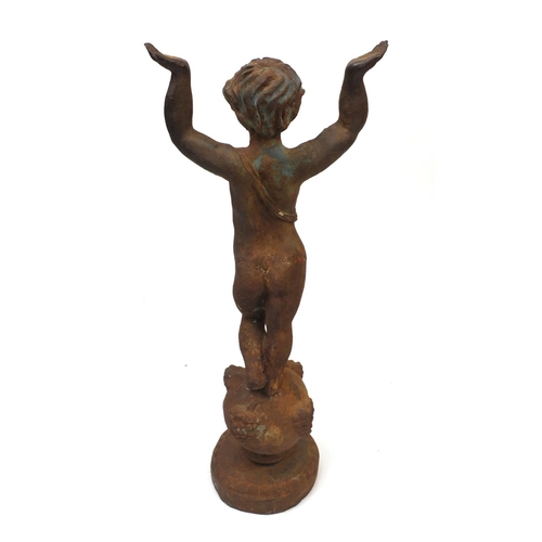 128 - Cast iron garden statue of a semi nude boy with raised arms, 80cm high