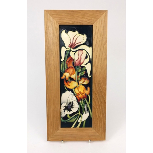 2061 - Boxed Moorcroft pottery wall plaque hand painted and tube lined with stylised flowers,  factory mark... 