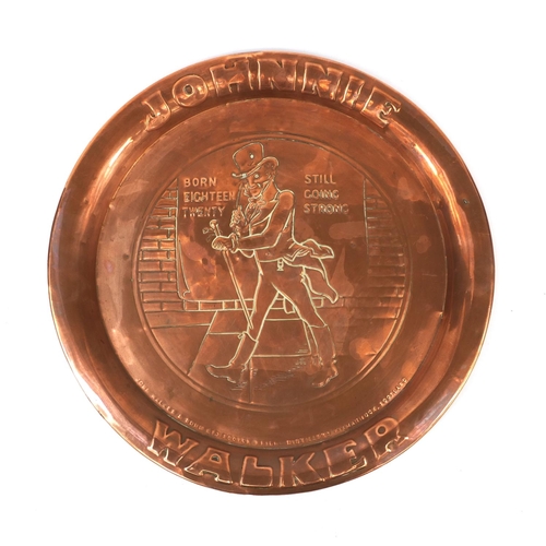 175 - Johnny Walker advertising embossed copper tray, 34cm in diameter