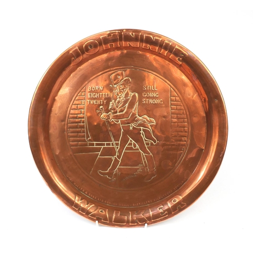 175 - Johnny Walker advertising embossed copper tray, 34cm in diameter