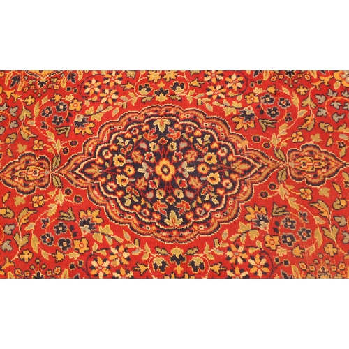 2006 - Rectangular Persian Kerman carpet, the central field and boarders with all over floral motifs onto a... 