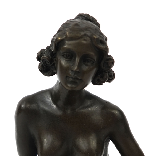 2073A - Bronze model of a seated nude female on a black marble base, 17cm high