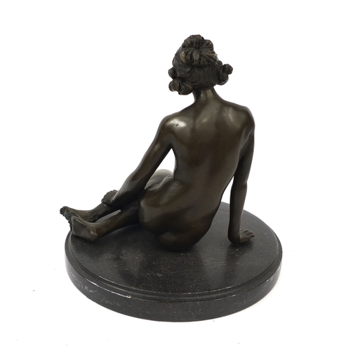 2073A - Bronze model of a seated nude female on a black marble base, 17cm high