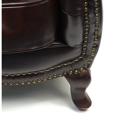 2009A - Pair of brown leather club chairs with horse shoe shaped back and button upholstery, 79cm high