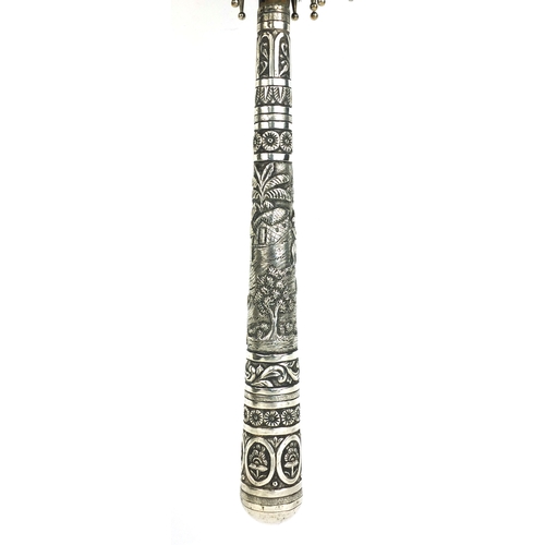 42 - Ebonised parasol with silver handle, profusely embossed with Oriental figures in a village amongst f... 