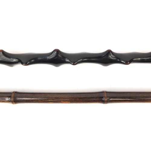 34 - Two wooden walking sticks including a bamboo example with gilt collar, the longest 91cm long