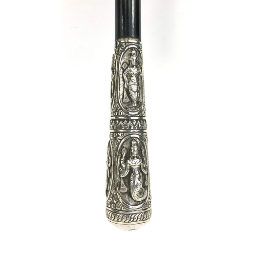 41 - Ebonised walking stick with silver pommel, embossed with Indian Goddesses, 93cm long