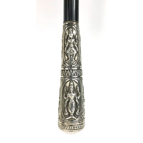 41 - Ebonised walking stick with silver pommel, embossed with Indian Goddesses, 93cm long