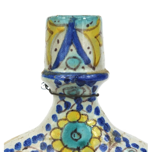 568 - Continenntal Isnik style pottery flask, hand painted with floral motifs, 24cm high