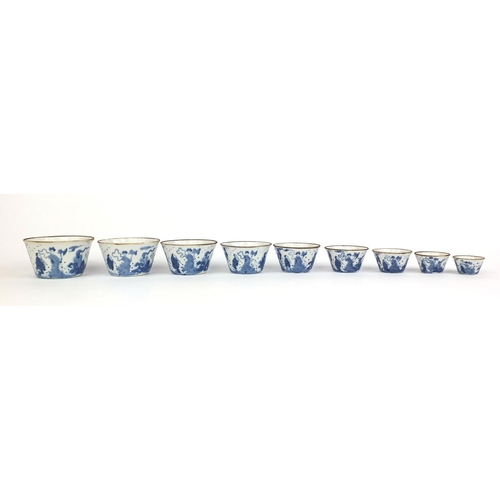 386 - Graduated set of nine Chinese blue and white porcelain bowls, each hand painted with a continuous ba... 