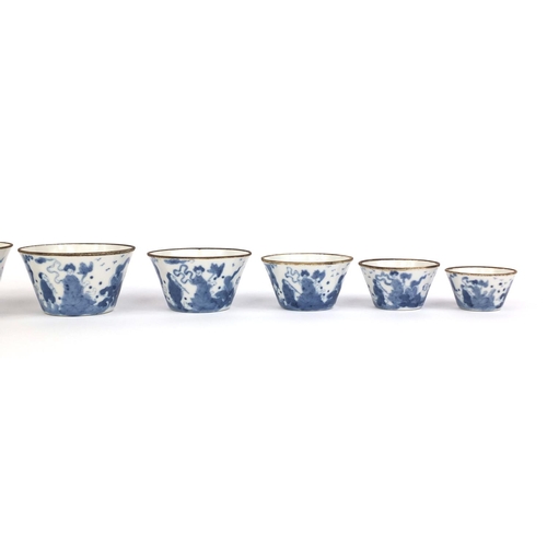 386 - Graduated set of nine Chinese blue and white porcelain bowls, each hand painted with a continuous ba... 